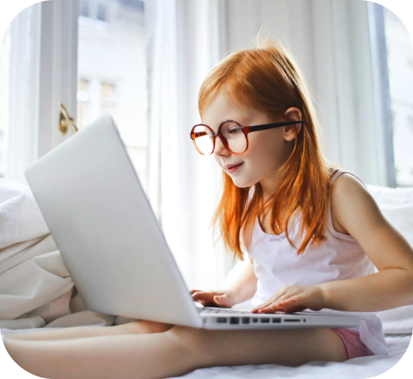 little girl studying on a computer